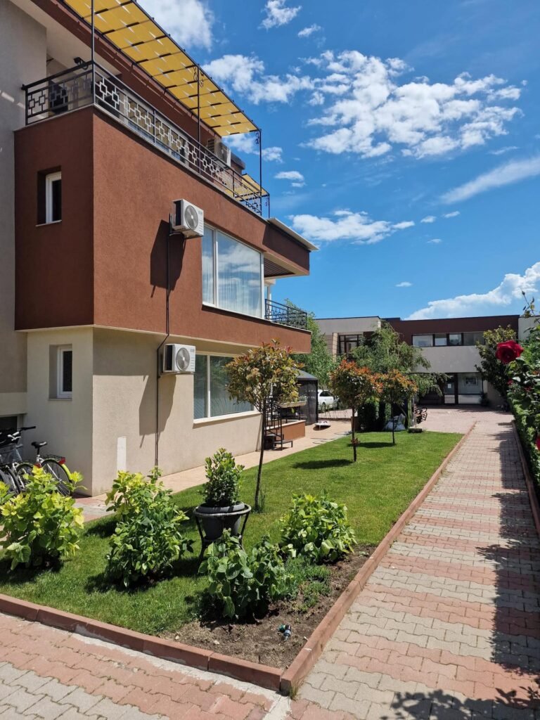 Sunlit inner courtyard of Ferano Beach Apartments in Nessebar
